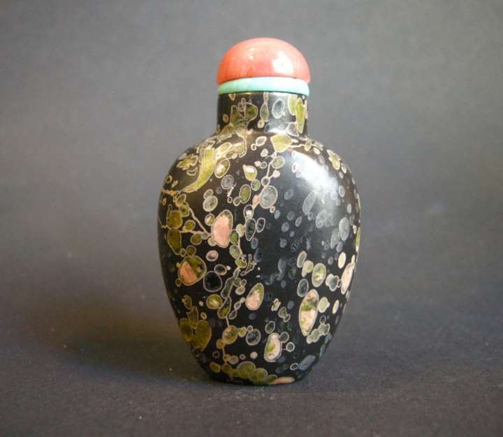 Rare snuff bottle Amydaloidal basalt where "pudding stone" volcanic with splash color on ground black